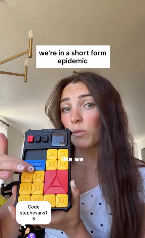 Steph holding a colorful GIIKER Super Slide puzzle