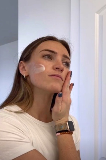 Steph applying a skincare product